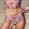 Floral patterned bikini set on a blurred beach background