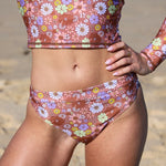 Floral patterned bikini set on a blurred beach background